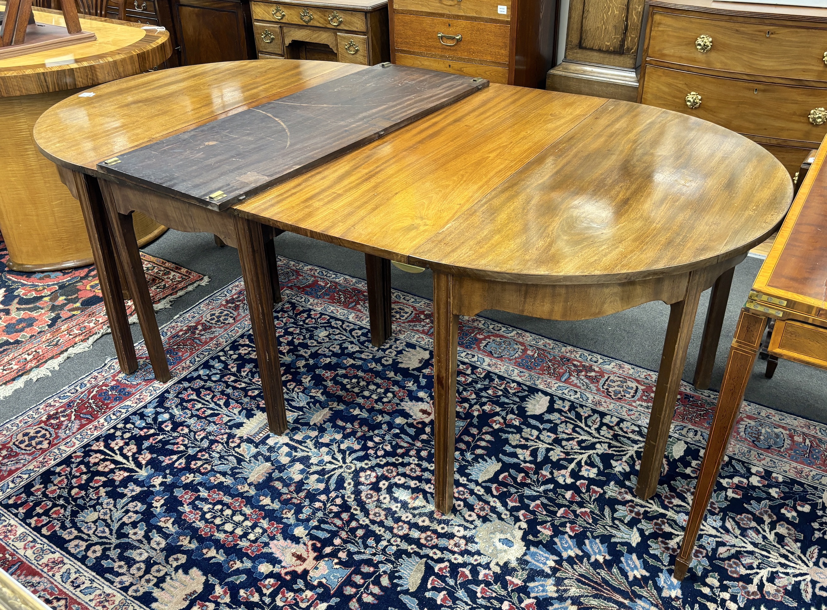 A George III mahogany D end extending dining table, 264cm extended, three spare leaves, width 121cm, height 72cm